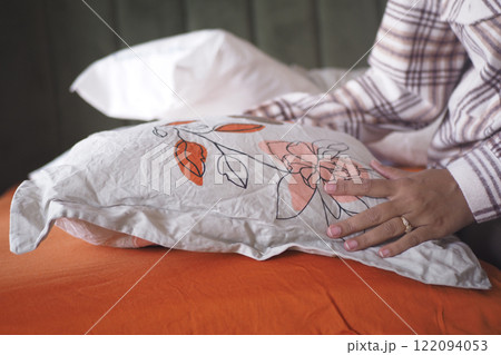 Woman Puts Pillow Into Pillowcase. Woman Puts Pillow Into Pillowcase. 122094053
