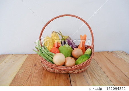 Basket of fresh vegetables on a wooden table. Healthy food. 122094222