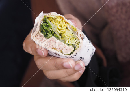A Freshly Made Wrap Filled with Tasty Greens and Juicy Chicken 122094310