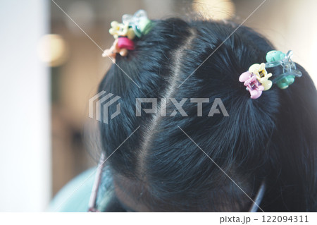 Adorable Hairstyle Featuring Vibrant Clips Enhancing Beautiful Dark Hair 122094311