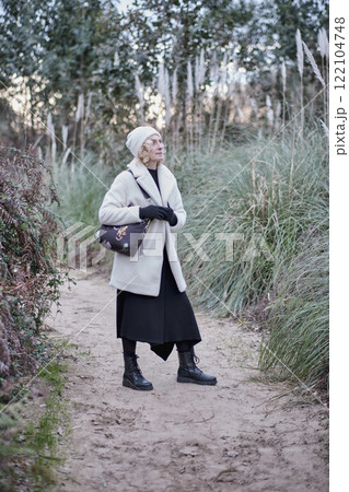 Stylish senior woman enjoying a peaceful walk in nature in cantabria, spain Stylish senior woman enjoying a peaceful walk in nature in cantabria, spain 122104748