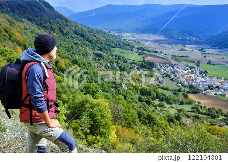 Hiker Admiring Scenic Landscape from a Mountain Viewpoint. 122104801