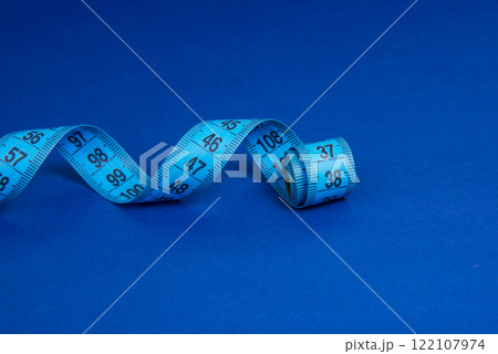 Colorful spiral tape measure on color background with space for text 122107974