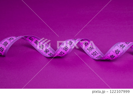 Colorful spiral tape measure on color background with space for text Colorful spiral tape measure on color background with space for text 122107999