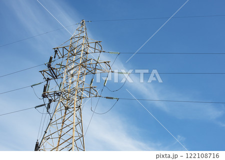 High voltage tower power lines on blue beautiful sky background High voltage tower power lines on blue beautiful sky background 122108716