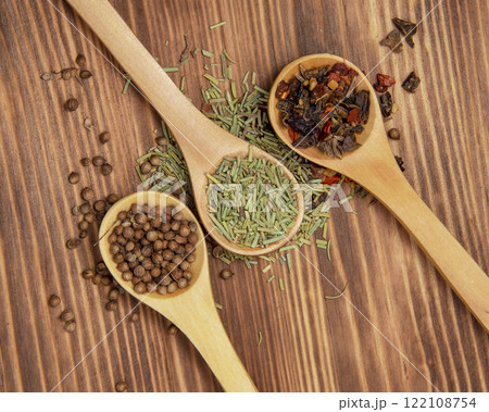 Three wooden spoon with different dry spices on natural wooden background Three wooden spoon with different dry spices on natural wooden background 122108754