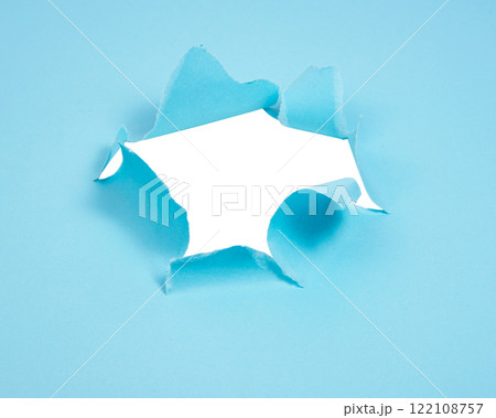 Blue torn paper whole with copyspace 122108757