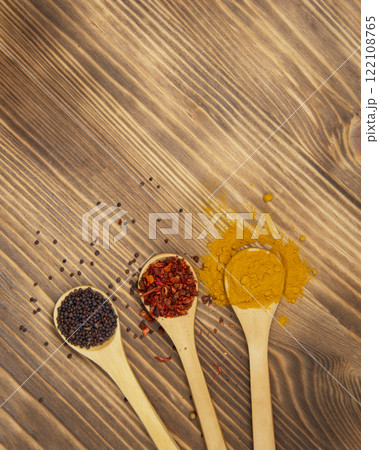 Aroma wooden spoon with different dry spices on natural wooden background Aroma wooden spoon with different dry spices on natural wooden background 122108765