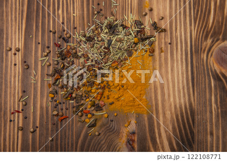 Dried different spices on wooden texture background Dried different spices on wooden texture background 122108771