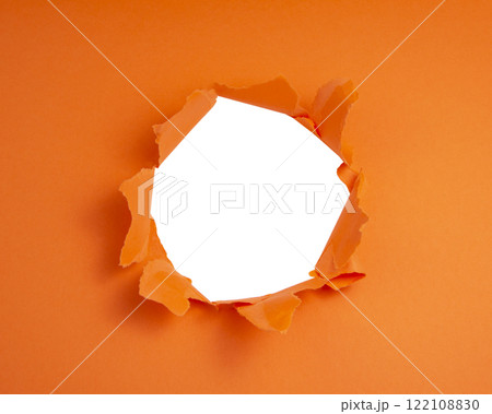 Torn hole paper orange color with copy space for text hallowen 122108830