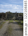 Rustic wooden gate with dry stone wall in a rural countryside 122108885