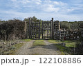 Rustic wooden gate with dry stone wall in a rural countryside 122108886