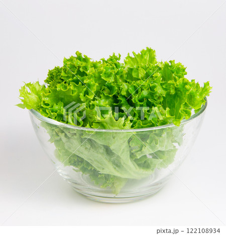 Green fresh salad of lettuce in glass dish on the white background 122108934
