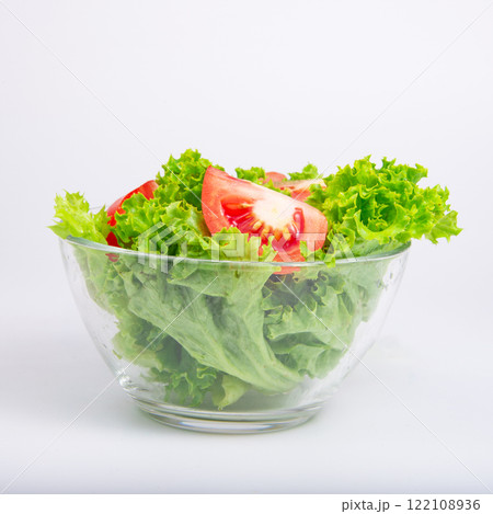 Green fresh salad of lettuce in glass dish on the white background 122108936