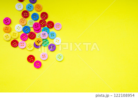Cloth buttons on the yellow background with copyspace 122108954