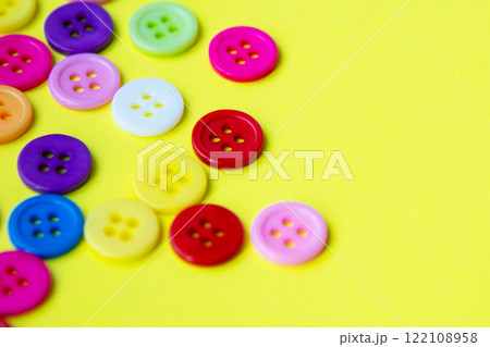 Cloth buttons on the yellow background with copyspace Cloth buttons on the yellow background with copyspace 122108958