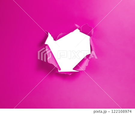 Pink color torn paper whole with copyspace 122108974