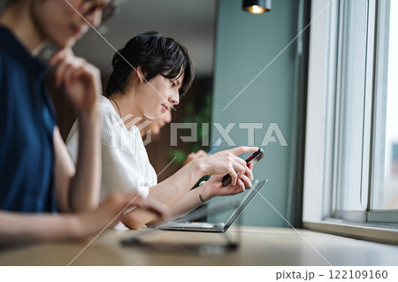 シェアオフィスでスマホを見る男性 122109160