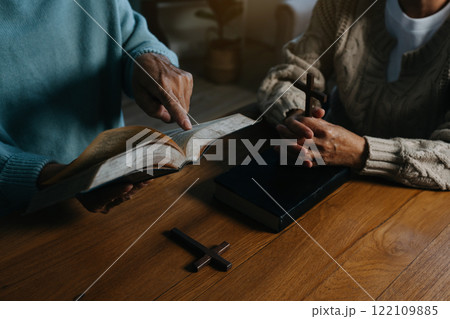 Men and women praying to God with the Bible, seeking blessings and guidance.  heartfelt depiction of faith, devotion, and spiritual connection. 122109885