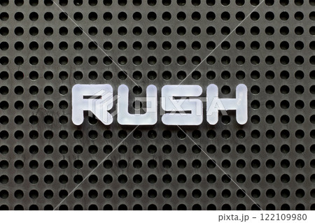 White color letter in word rush on black pegboard background White color letter in word rush on black pegboard background 122109980