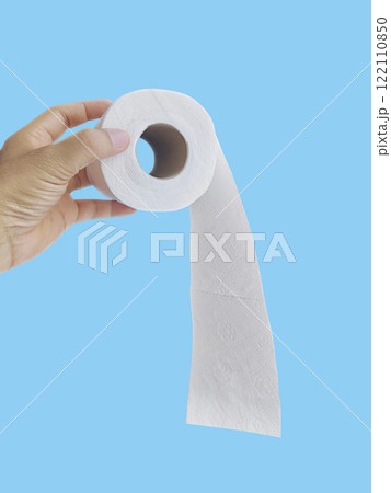 Hand Holding a Roll of Toilet Paper on blue background Hand Holding a Roll of Toilet Paper on blue background 122110850
