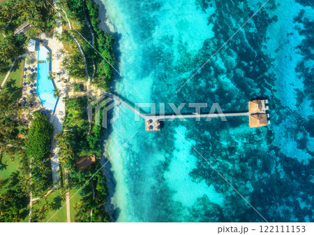 Aerial view of bungalow, white sandy beach, blue sea and palms Aerial view of bungalow, white sandy beach, blue sea and palms 122111153