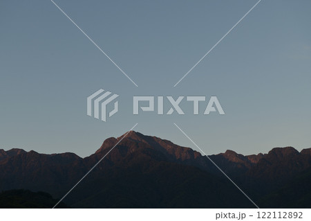 北杜市白州町、雲ひとつない快晴の空、南アルプス甲斐個が岳の峰を赤く染める早朝の太陽 北杜市白州町、雲ひとつない快晴の空、南アルプス甲斐個が岳の峰を赤く染める早朝の太陽 122112892