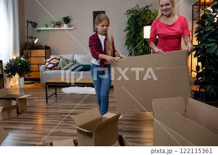 Relishing in precious Family Bonding Moments While Unpacking Moving Boxes Together as a Team 122115361