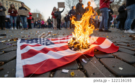 Protesters gather to demonstrate with a burning flag on the street during a heated rally for social justice Protesters gather to demonstrate with a burning flag on the street during a heated rally for social justice 122116193