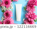 White moisturizing Cream tube, pink chrysanthemum flowers on blue background. Cosmetic skincare product blank plastic package. Bottle of moisturizer, sunscreen lotion, balsam, toothpaste mockup 122116669