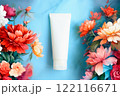 Cosmetic tube, painted pink peonies on blue background. White moisturizing Cream, skincare product blank mockup package. Bottle of moisturizer, sunscreen lotion, balsam, toothpaste, scrub 122116671