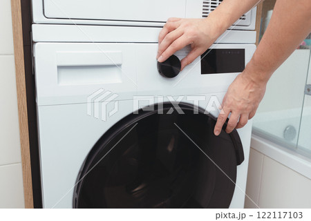 White washing machine in a utility room White washing machine in a utility room 122117103