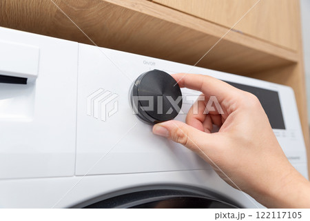 White washing machine in a utility room 122117105