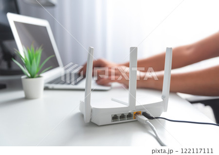 Fast internet concept with modern WiFi router Fast internet concept with modern WiFi router 122117111
