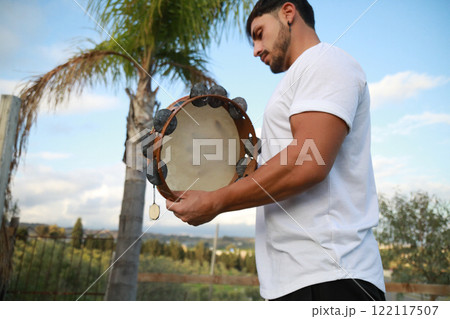 Skilled Tambourine Player in Vast Countryside 122117507
