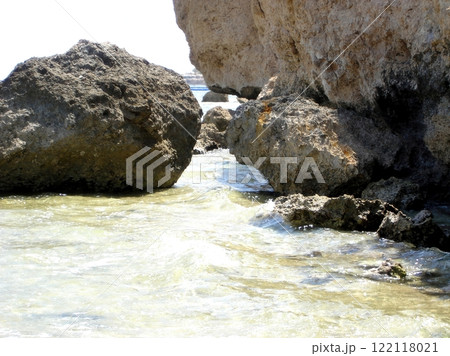 Rocky Desert Shore of the Red Sea With Clear Waters and Tidal Movement Under Bright Sunlight Rocky Desert Shore of the Red Sea With Clear Waters and Tidal Movement Under Bright Sunlight 122118021