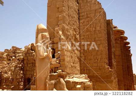 Exploring the Ancient Karnak Temple Complex With Grand Statue and Impressive Stone Wall in Egypt Exploring the Ancient Karnak Temple Complex With Grand Statue and Impressive Stone Wall in Egypt 122118282