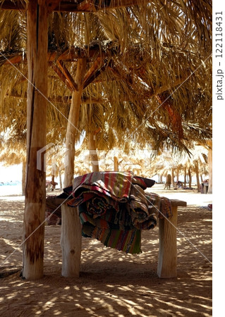 Relaxing by the Beach Under a Canopy Enjoying the Sun at Paradise Island Hurghada Relaxing by the Beach Under a Canopy Enjoying the Sun at Paradise Island Hurghada 122118431