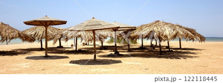 Relaxing Under Beach Umbrellas at Paradise Island in Hurghada Along the Stunning Red Sea Coast Relaxing Under Beach Umbrellas at Paradise Island in Hurghada Along the Stunning Red Sea Coast 122118445