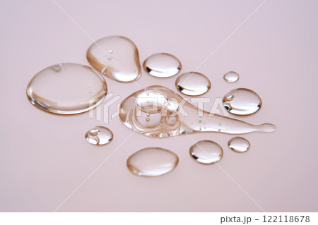 Few drops of serum on a beige background. 122118678