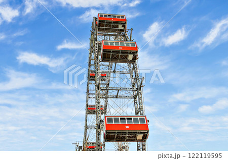 Ferris wheel with red cabins of the Prater amusement park in Vienna, Austria. Ferris wheel with red cabins of the Prater amusement park in Vienna, Austria. 122119595