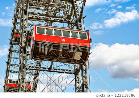 Ferris wheel with red cabins of the Prater amusement park in Vienna, Austria. Ferris wheel with red cabins of the Prater amusement park in Vienna, Austria. 122119596