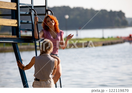 Enjoying the Summer by the Water Engaging Conversations and Relaxation with Friends and Fun 122119870