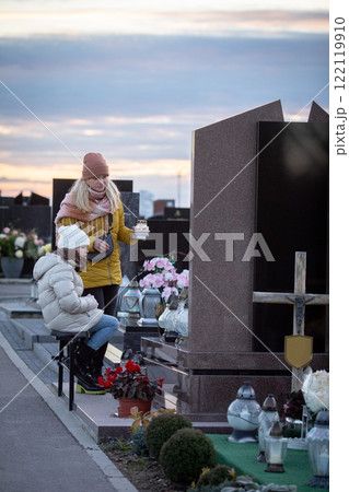 Visiting the grave of a cherished loved one at dusk can be a deeply emotional experience Visiting the grave of a cherished loved one at dusk can be a deeply emotional experience 122119910