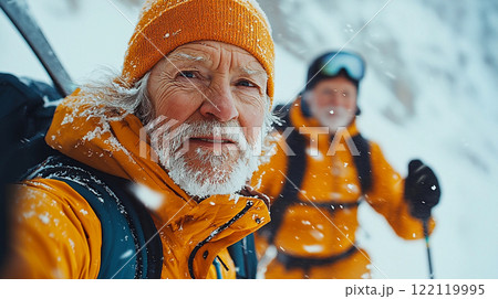 Elderly couple enjoying cross-country skiing adventure in a snowy landscape while dressed warmly for winter activities 122119995