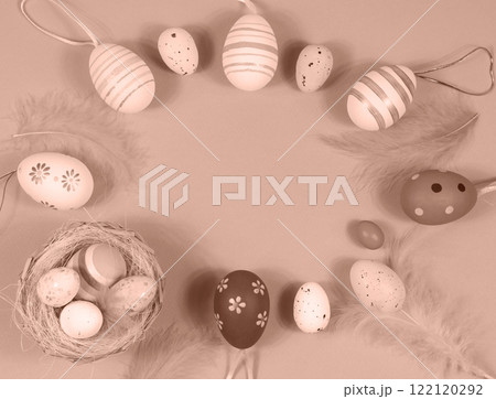 Easter frame with eggs and feathers. Demonstrating color of 2025 year mocha mousse Easter frame with eggs and feathers. Demonstrating color of 2025 year mocha mousse 122120292
