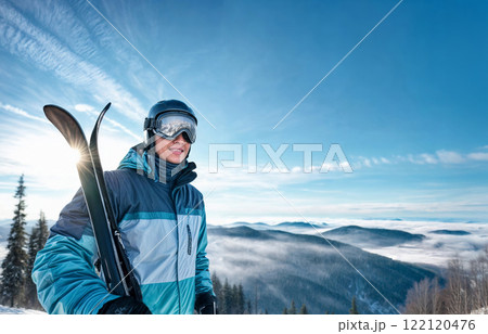 Winter Sports Enthusiast with Ski Equipment on a Scenic Mountain Slope 122120476