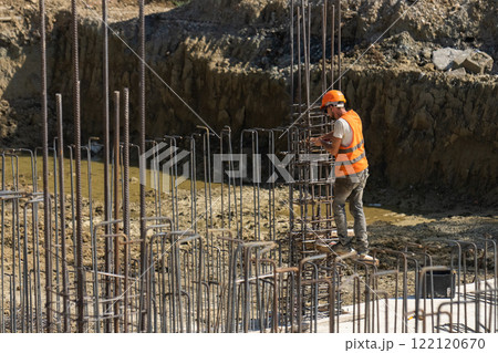 Builders work with reinforcement wire. Builders work with reinforcement wire. 122120670