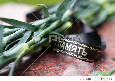 Close-up of flowers on a grave. 122120713