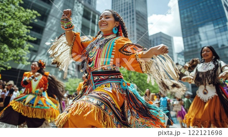 Indigenous women in vibrant traditional regalia dance joyfully in a modern city setting. Indigenous women in vibrant traditional regalia dance joyfully in a modern city setting. 122121698